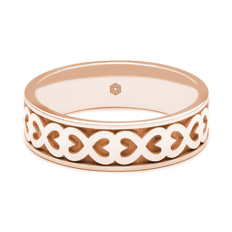 Horizontal Shot of Mens 9ct Rose Gold Flat Court Wedding Ring With Hearts Pattern