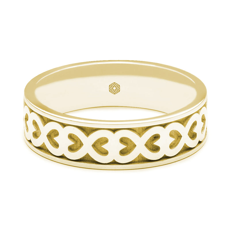 Horizontal Shot of Mens 9ct Yellow Gold Flat Court Wedding Ring With Hearts Pattern